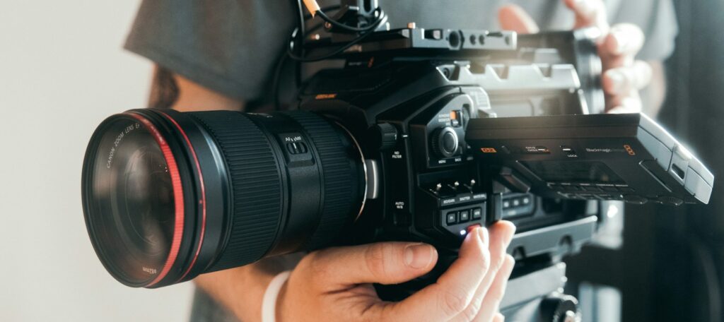 person holding black dslr camera