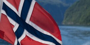 A flag flying from a boat in a body of water