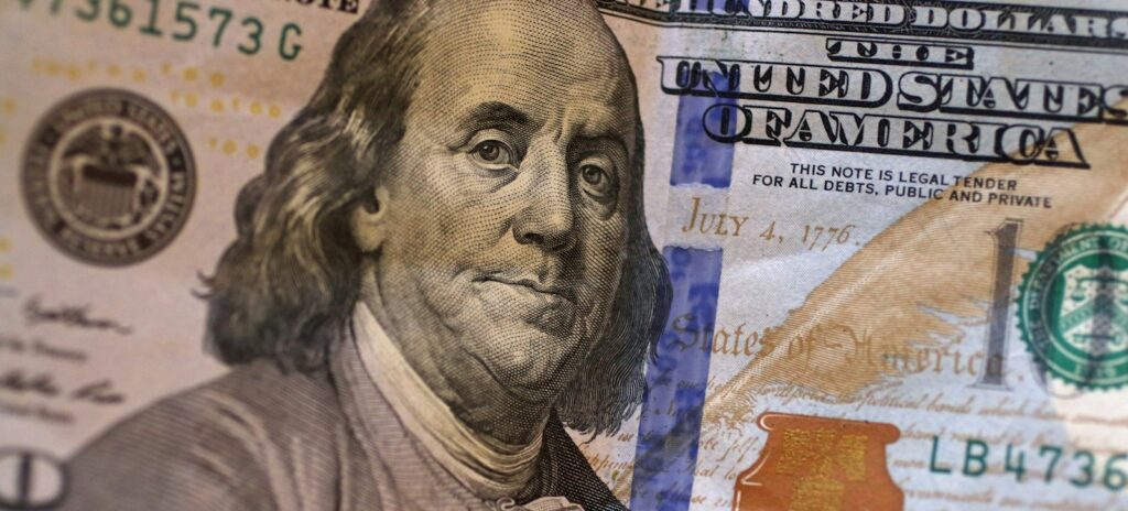 A stack of twenty dollar bills sitting on top of each other