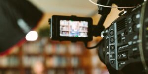 person sitting in front bookshelf